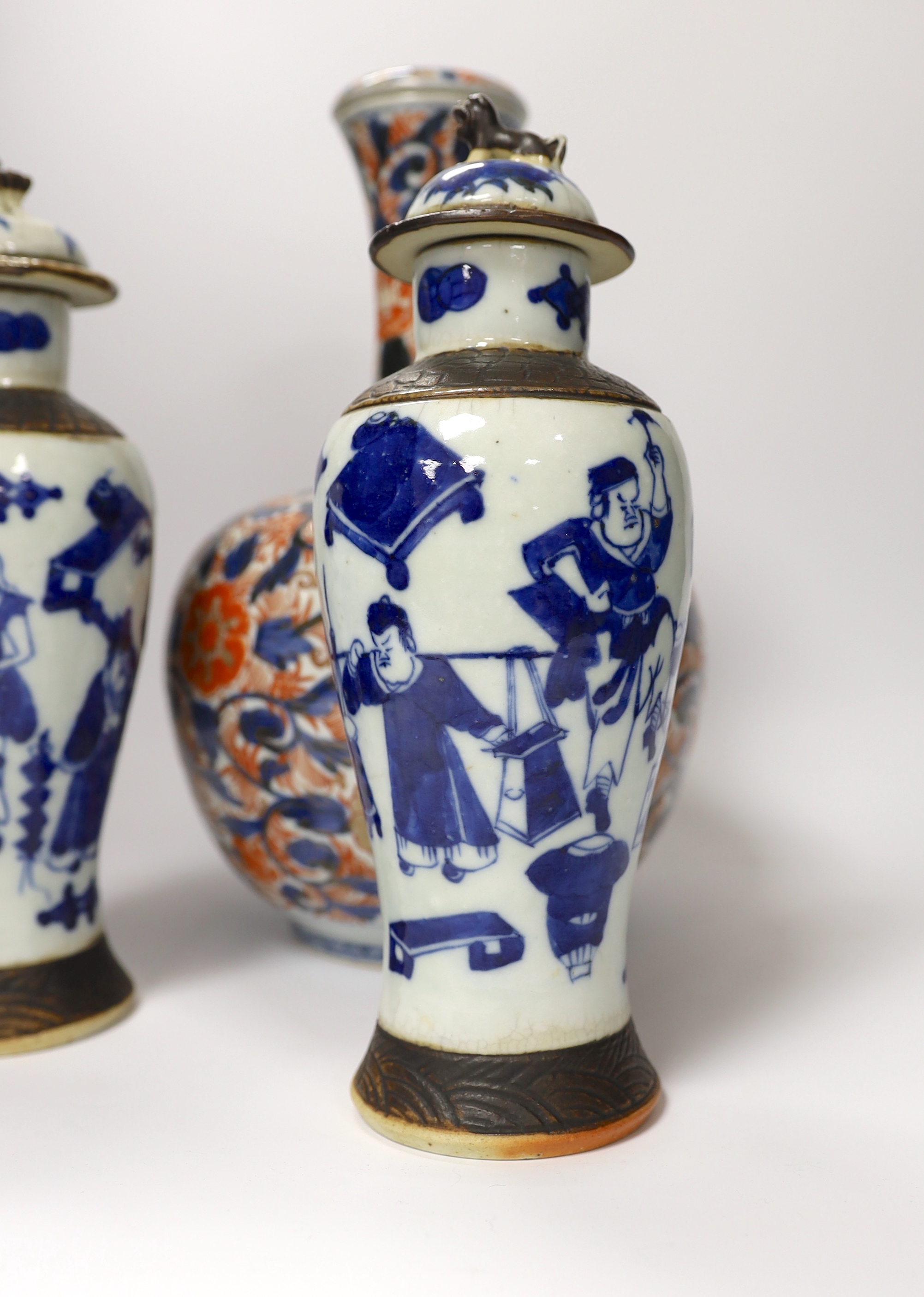 A pair of Chinese blue and white crackleware vases and covers and an Imari vase and cover, largest 31cm high